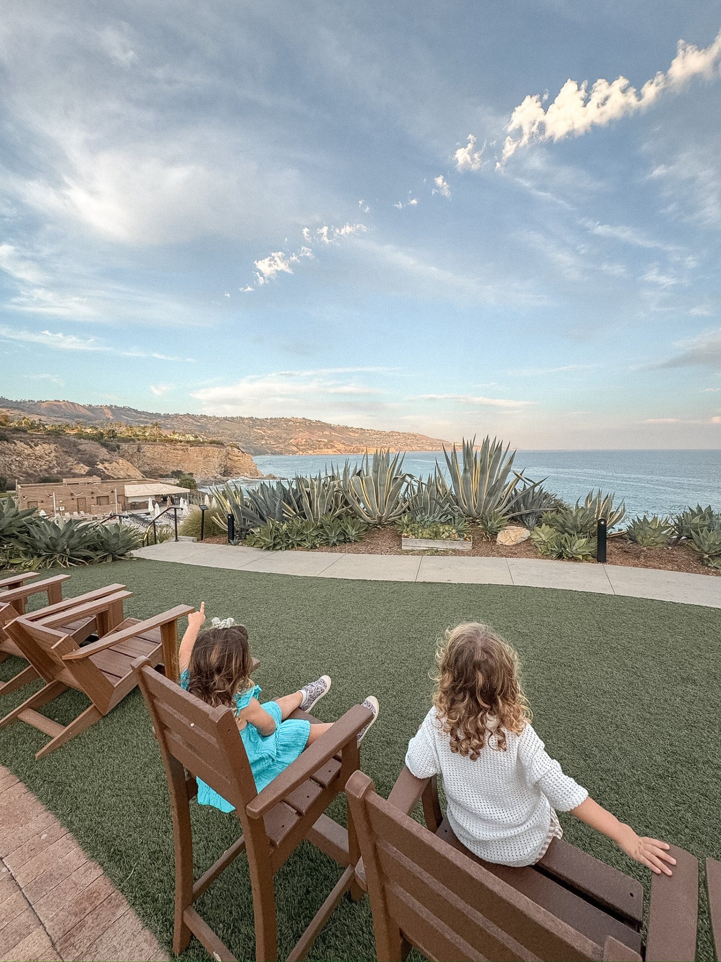 Our twins in Adirondack chairs overlooking the Terranea coastline