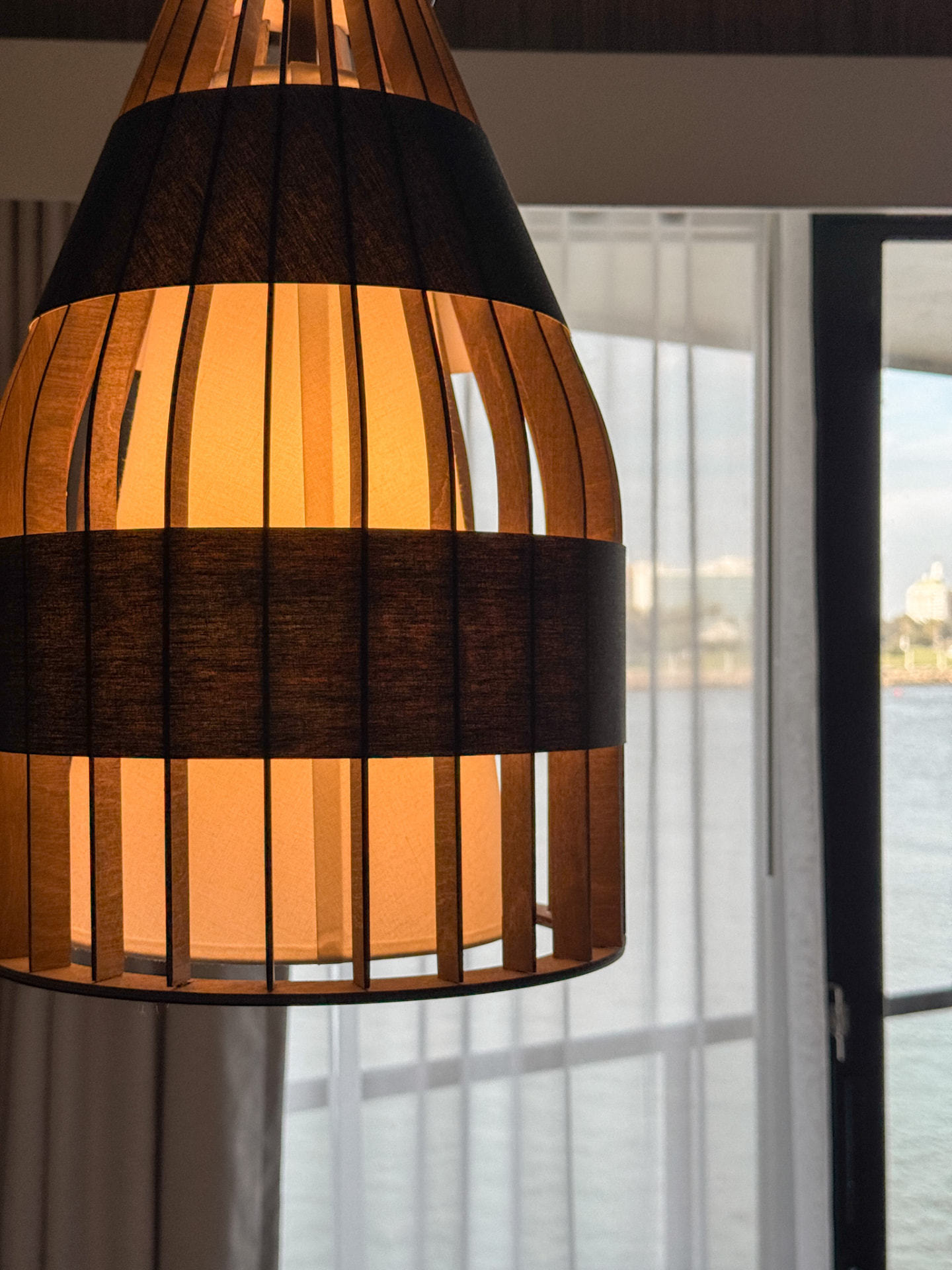An editorial detail at The Maya: a lamp and still water at dusk
