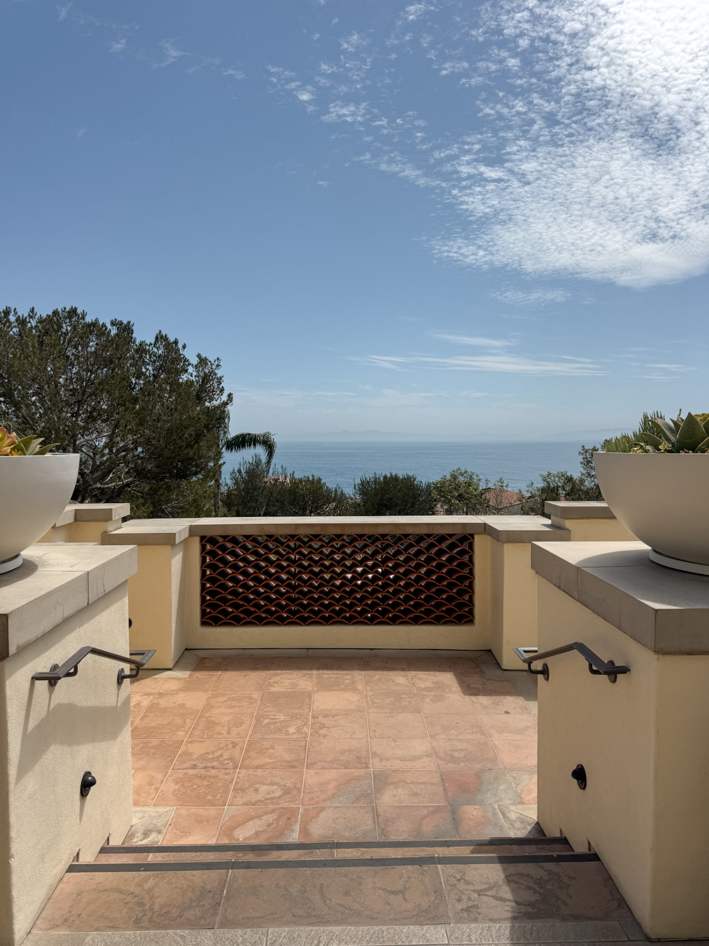 The stone architecture and terraces of Terranea Resort with the Pacific beyond