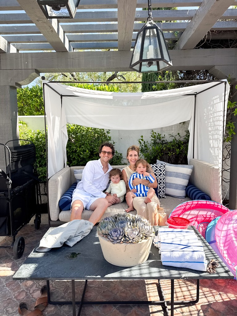 The family sitting together on a lawn at the Ojai Valley Inn