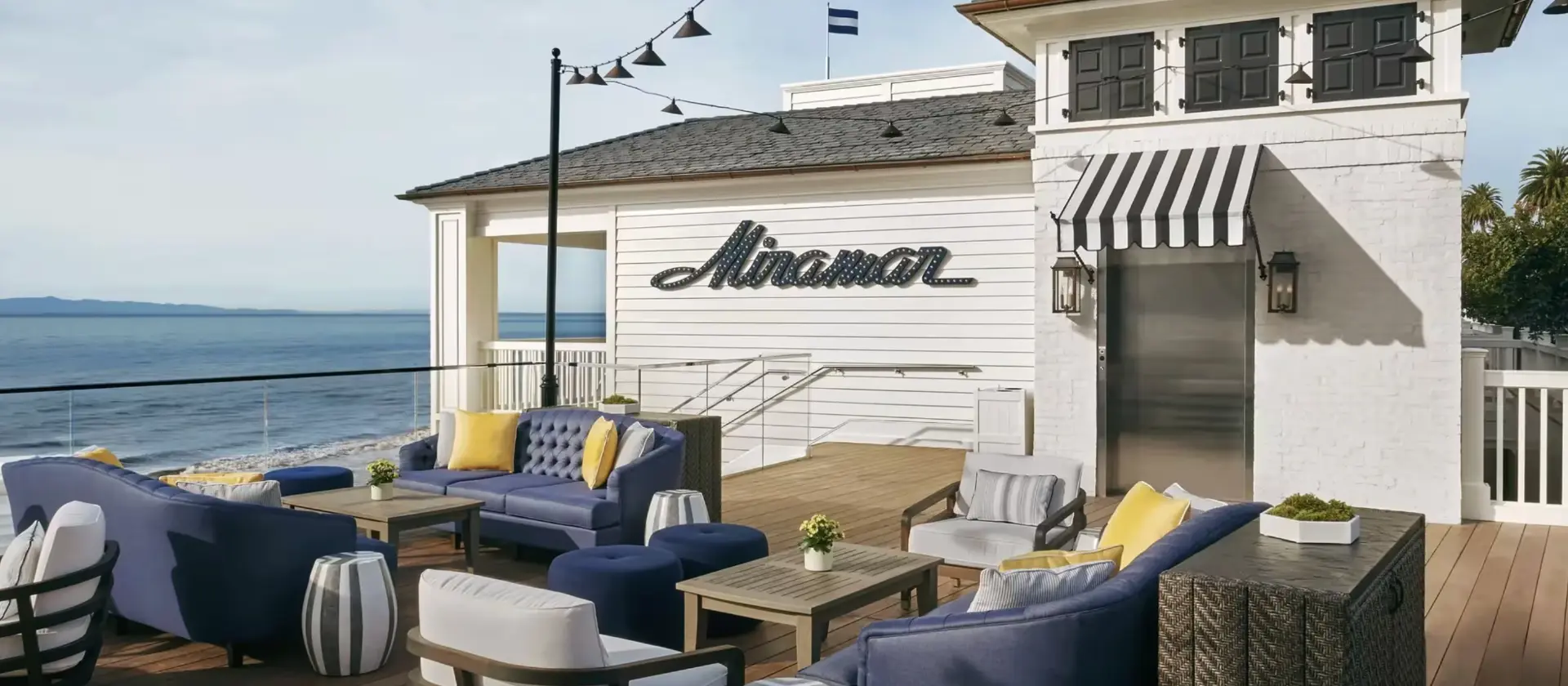 White cabanas and hedges at a beachfront hotel