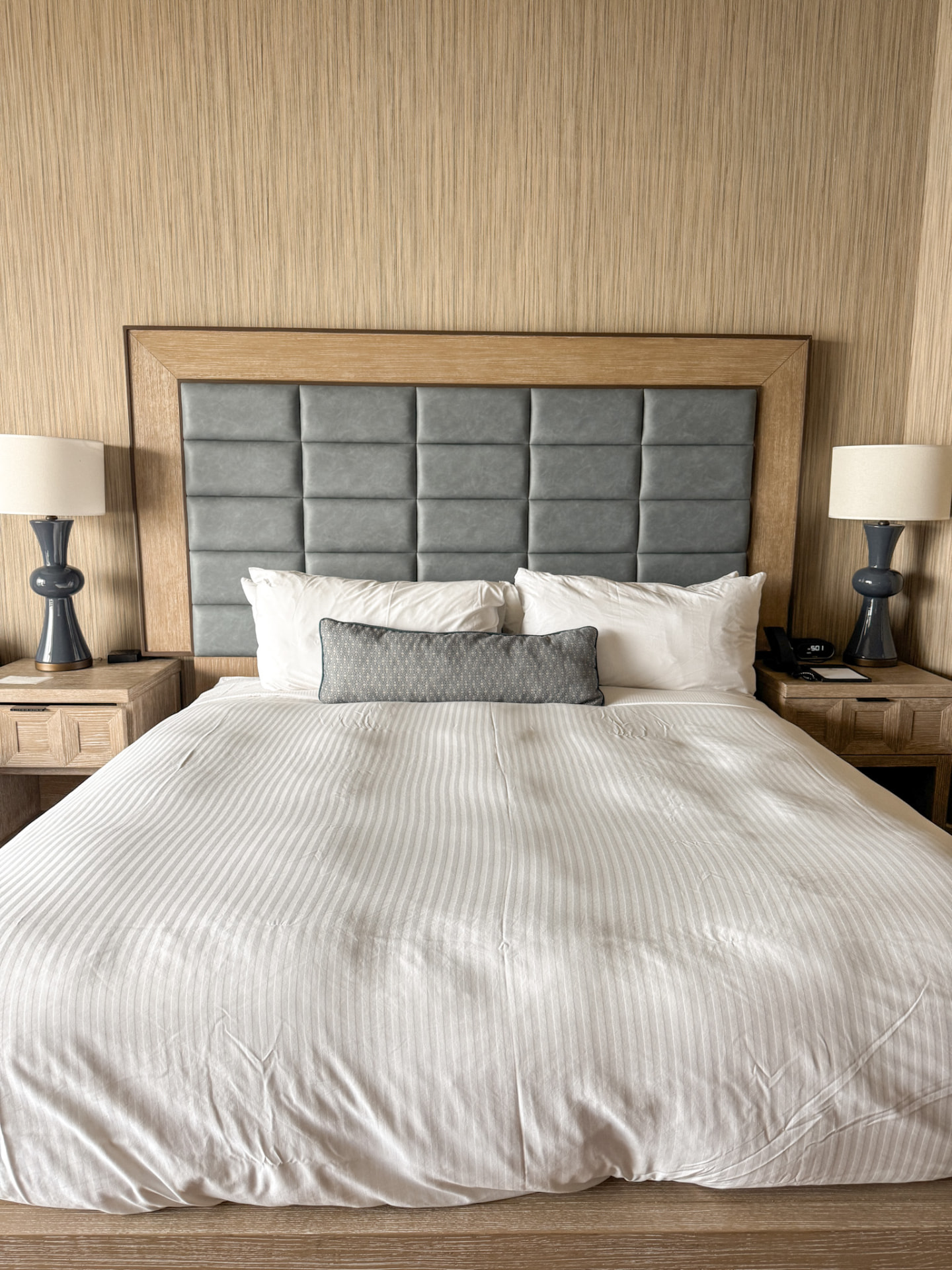 A made guest room bed at The Maya