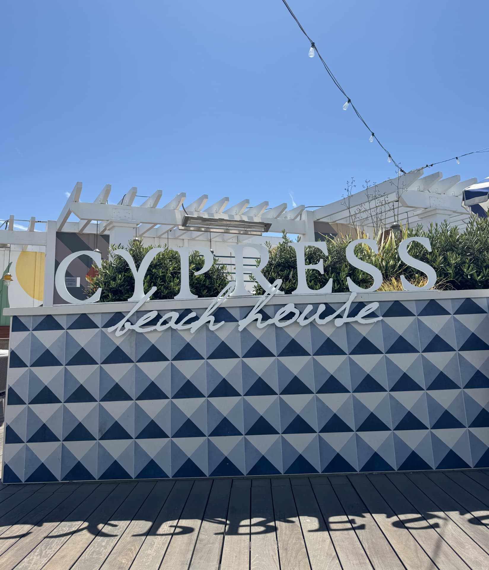 The Cypress Beach House sign on the rooftop at Inn at the Pier in Pismo Beach