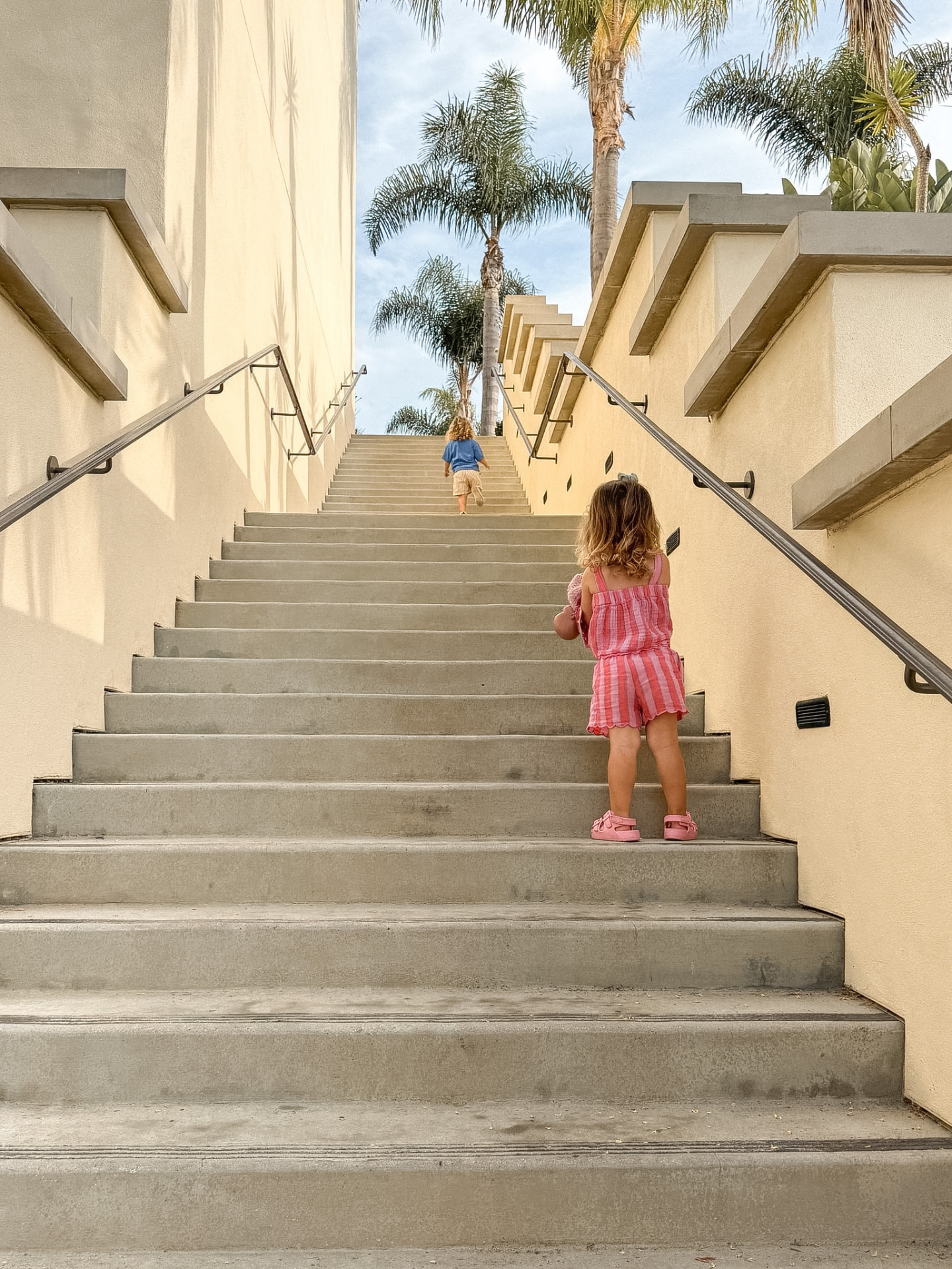 Our twins working their way up a large resort staircase
